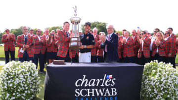 FORT WORTH, TEXAS - MAY 26: Colonial Country Club president Kip Adams (left) presents Kevin Na of the United States with the trophy as Charles Schwab (right) looks on after Na won the 2019 Charles Schwab Challenge at Colonial Country Club on May 26, 2019 in Fort Worth, Texas. (Photo by Tom Pennington/Getty Images)