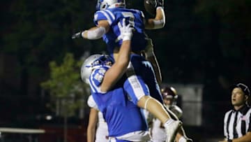 Whitefish Bay Grover Bortolotti (7) celebrates a touchdown with teammate Whitefish Bay Joe Brunner (52) during the prep football game between West Bend East and Whitefish Bay on Friday, Sept. 25, 2020.Bay25 02 Wood