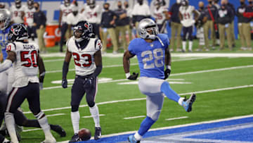 DETROIT, MICHIGAN - NOVEMBER 26: Adrian Peterson #28 of the Detroit Lions celebrates a touchdown during the first half against the Houston Texans at Ford Field on November 26, 2020 in Detroit, Michigan. (Photo by Gregory Shamus/Getty Images)