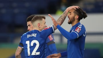 Everton's English striker Dominic Calvert-Lewin (R) celebrates scoring his team's first goalduring the English FA Cup fifth round football match betwee n Everton and Tottenham Hotspur at Goodison Park in Liverpool, north west England on February 10, 2021. (Photo by Clive Brunskill / POOL / AFP) / RESTRICTED TO EDITORIAL USE. No use with unauthorized audio, video, data, fixture lists, club/league logos or 'live' services. Online in-match use limited to 120 images. An additional 40 images may be used in extra time. No video emulation. Social media in-match use limited to 120 images. An additional 40 images may be used in extra time. No use in betting publications, games or single club/league/player publications. / (Photo by CLIVE BRUNSKILL/POOL/AFP via Getty Images)
