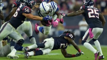 Oct 9, 2014; Houston, TX, USA; Indianapolis Colts running back Trent Richardson (34) is defended by Houston Texans linebacker Brian Cushing (56), safety Kendrick Lewis (21) and cornerback KareeM Jackson (25) at NRG Stadium. Mandatory Credit: Kirby Lee-USA TODAY Sports