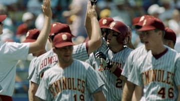 OMAHA, NE - JUNE 6: Doug Mientkiewicz #25 of the Florida State Seminoles high fives teammates after a home run during the game against the USC Trojans in the 1995 College World Series at Rosenblatt Stadium on June 6, 1995 in Omaha, Nebraska. (Photo by Andy Lyons/Getty Images)