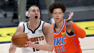 Nikola Jokic #15 of the Denver Nuggets goes to the basket against Isaiah Roby #22 of the OKC Thunder (Photo by Matthew Stockman/Getty Images)