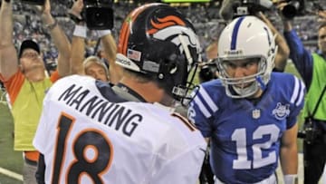 Oct 20, 2013; Indianapolis, IN, USA; Denver Broncos quarterback Peyton Manning (18) shakes hands with Indianapolis Colts quarterback Andrew Luck (12) before the game at Lucas Oil Stadium. Mandatory Credit: Thomas J. Russo-USA TODAY Sports