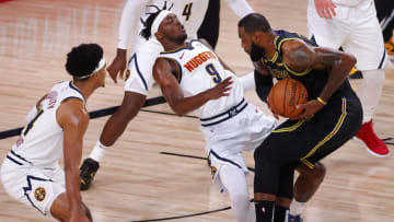 LAKE BUENA VISTA, FLORIDA - SEPTEMBER 20: LeBron James #23 of the Los Angeles Lakers draws a blocking foul from Jerami Grant #9 of the Denver Nuggets during the first quarter in Game Two of the Western Conference Finals during the 2020 NBA Playoffs at AdventHealth Arena at the ESPN Wide World Of Sports Complex on September 20, 2020 in Lake Buena Vista, Florida. NOTE TO USER: User expressly acknowledges and agrees that, by downloading and or using this photograph, User is consenting to the terms and conditions of the Getty Images License Agreement. (Photo by Kevin C. Cox/Getty Images)