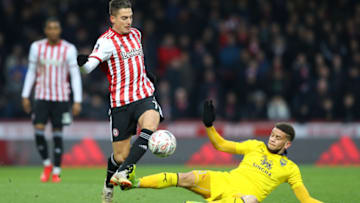 BRENTFORD, ENGLAND - JANUARY 05: Sergi Canos of Brentford is fouled by Marcus Browne of Oxford United during the FA Cup Third Round match between Brentford and Oxford United at Griffin Park on January 5, 2019 in Brentford, United Kingdom. (Photo by Warren Little/Getty Images)