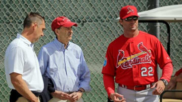 Feb 18, 2016; Jupiter, FL, USA; St. Louis Cardinals manager Mike Matheny (right) listens as general manager John Mozeliak (left) talks with chairman and chief executive officer William O. DeWitt, Jr. (center) at Roger Dean Stadium. Mandatory Credit: Steve Mitchell-USA TODAY Sports