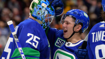 VANCOUVER, BC - OCTOBER 12: Vancouver Canucks Goaltender Jacob Markstrom (25) and Defenseman Troy Stecher (51) celebrate a win against the Philadelphia Flyers after their NHL game at Rogers Arena on October 12, 2019 in Vancouver, British Columbia, Canada. Vancouver won 3-2. (Photo by Derek Cain/Icon Sportswire via Getty Images)