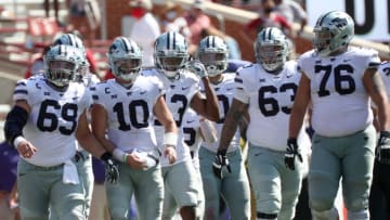 Sep 26, 2020; Norman, Oklahoma, USA; Kansas State Wildcats offensive lineman Noah Johnson (69) and quarterback Skylar Thompson (10) and offensive lineman Ben Adler (63) and offensive lineman Josh Rivas (76) walk out to take the last snap during the fourth quarter against the Oklahoma Sooners at Gaylord Family Oklahoma Memorial Stadium. Mandatory Credit: Kevin Jairaj-USA TODAY Sports