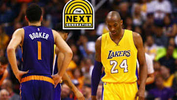 Mar 23, 2016; Phoenix, AZ, USA; Los Angeles Lakers guard Kobe Bryant (24) reacts alongside Phoenix Suns guard Devin Booker (1) at Talking Stick Resort Arena. The Suns defeated the Lakers 119-107. Mandatory Credit: Mark J. Rebilas-USA TODAY Sports