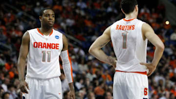 BUFFALO, NY - MARCH 19: Scoop Jardine #11 and Andy Rautins #1 of the Syracuse Orange look on against the Vermont Catamounts during the first round of the 2010 NCAA men's basketball tournament at HSBC Arena on March 19, 2010 in Buffalo, New York. (Photo by Michael Heiman/Getty Images)