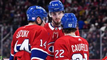 MONTREAL, CANADA - NOVEMBER 29: Nick Suzuki #14, Kirby Dach #77 and Cole Caufield #22 of the Montreal Canadiens huddle during the second period against the San Jose Sharks at Centre Bell on November 29, 2022 in Montreal, Quebec, Canada. The San Jose Sharks defeated the Montreal Canadiens 4-0. (Photo by Minas Panagiotakis/Getty Images)