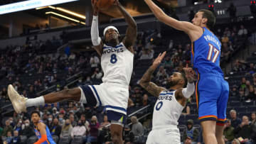 Minnesota Timberwolves forward Jarred Vanderbilt pulls down a rebound in front of D'Angelo Russell and Oklahoma City Thunder forward Aleksej Pokusevski. Mandatory Credit: Nick Wosika-USA TODAY Sports