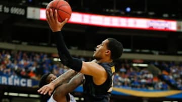 Mar 14, 2014; Atlanta, GA, USA; Missouri Tigers guard Jabari Brown (32) drives to the basket against Florida Gators forward Chris Walker (23) in the quarterfinals of the SEC college basketball tournament at Georgia Dome. Florida won 72-49. Mandatory Credit: Paul Abell-USA TODAY Sports
