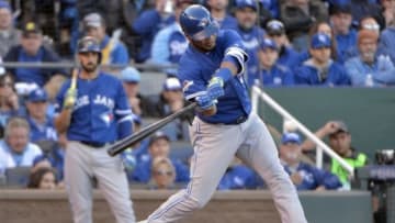 Oct 17, 2015; Kansas City, MO, USA; Toronto Blue Jays designated hitter Edwin Encarnacion (10) hits an RBI single during the sixth inning against the Kansas City Royals in game two of the ALCS at Kauffman Stadium. Mandatory Credit: Denny Medley-USA TODAY Sports