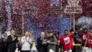 ATLANTA, GA - DECEMBER 31: head coach Kirby Smart of the Georgia Bulldogs is given the trophy for winning the Peach Bowl during a game between Ohio State Buckeyes and Georgia Bulldogs at Mercedes-Benz Stadium on December 31, 2022 in Atlanta, Georgia. (Photo by Steve Limentani/ISI Photos/Getty Images)