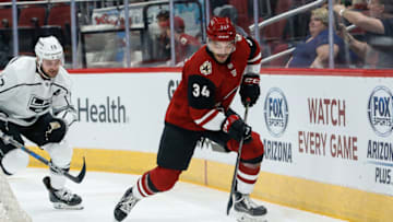 GLENDALE, AZ - SEPTEMBER 18: Arizona Coyotes defenseman Robbie Russo (34) controls the puck during the preseason NHL hockey game between the Los Angeles Kings and the Arizona Coyotes on Sep 18, 2018 at Gila River Arena in Glendale, Arizona. (Photo by Kevin Abele/Icon Sportswire via Getty Images)