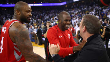 OAKLAND, CA - OCTOBER 17: PJ Tucker #4, Chris Paul #3 and team owner Tilman Fertitta of the Houston Rockets celebrate after defeating the Golden State Warriors 122-121 in their NBA game at ORACLE Arena on October 17, 2017 in Oakland, California. NOTE TO USER: User expressly acknowledges and agrees that, by downloading and or using this photograph, User is consenting to the terms and conditions of the Getty Images License Agreement. (Photo by Ezra Shaw/Getty Images)