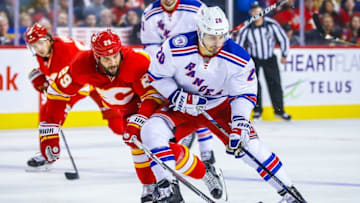 Nov 12, 2016; Calgary, Alberta, CAN; New York Rangers left wing Chris Kreider (20) and Calgary Flames defenseman Deryk Engelland (29) battle for the puck during the third period at Scotiabank Saddledome. New York Rangers won 4-1. Mandatory Credit: Sergei Belski-USA TODAY Sports