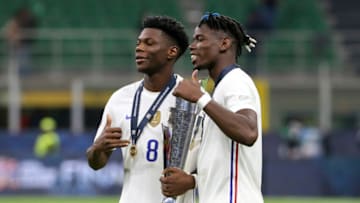 MILAN, ITALY - OCTOBER 10: Aurelien Tchouameni, Paul Pogba of France - holding the trophy - celebrate the victory following the UEFA Nations League 2021 Final match between Spain and France at Stadio San Siro stadium aka Stadio Giuseppe Meazza stadium on October 10, 2021 in Milan, Italy. (Photo by John Berry/Getty Images)