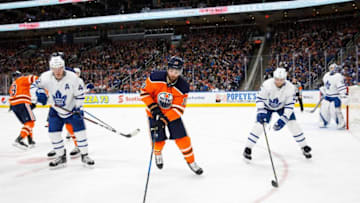 EDMONTON, AB - NOVEMBER 30: Patrick Maroon #19 of the Edmonton Oilers is watched by Morgan Rielly #44 and Ron Hainsey #2 of the Toronto Maple Leafs at Rogers Place on November 30, 2017 in Edmonton, Canada. (Photo by Codie McLachlan/Getty Images)