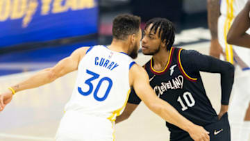 Apr 15, 2021; Cleveland, Ohio, USA; Cleveland Cavaliers guard Darius Garland (10) and Golden State Warriors guard Stephen Curry (30) embrace before tipoff at Rocket Mortgage FieldHouse. Mandatory Credit: Scott Galvin-USA TODAY Sports