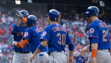 PHILADELPHIA, PA - AUGUST 16: Wilmer Flores #4, Jose Bautista #11, Michael Conforto #30, and Todd Frazier #21 of the New York Mets celebrate a grand slam by Bautista in the top of the fifth inning against the Philadelphia Phillies in game one of the doubleheader at Citizens Bank Park on August 16, 2018 in Philadelphia, Pennsylvania. The Mets defeated the Phillies 24-4. (Photo by Mitchell Leff/Getty Images)