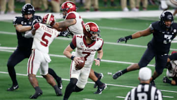 Dec 19, 2020; Arlington, Texas, USA; Oklahoma Sooners quarterback Spencer Rattler (7) rolls out in the second quarter against the Iowa State Cyclones at AT&T Stadium. Mandatory Credit: Tim Heitman-USA TODAY Sports