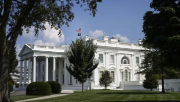 WASHINGTON, DC - AUGUST 27: The American flag and National League of Families POW/MIA Flag on top of the White House stand at half staff to honor the U.S. service members killed in terror attacks in Kabul Afghanistan, on August 27, 2021 in Washington, DC. The death toll from the two terror attacks in Kabul Afghanistan stands at over 90, including 13 U.S. service members and dozens of Afghans.(Photo by Drew Angerer/Getty Images)