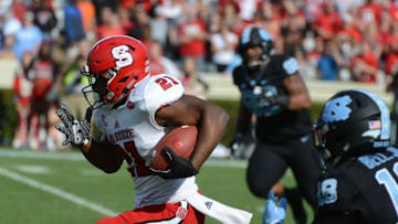 Nov 25, 2016; Chapel Hill, NC, USA; North Carolina State Wolfpack running back Matt Dayes (21) runs the ball during the first half against the North Carolina Tar Heels at Kenan Memorial Stadium. Mandatory Credit: Rob Kinnan-USA TODAY Sports