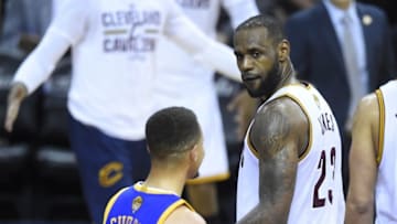 Jun 16, 2016; Cleveland, OH, USA; Cleveland Cavaliers forward LeBron James (23) stares at Golden State Warriors guard Stephen Curry (30) in the fourth quarter in game six of the NBA Finals at Quicken Loans Arena. Cleveland won 115-101. Mandatory Credit: David Richard-USA TODAY Sports