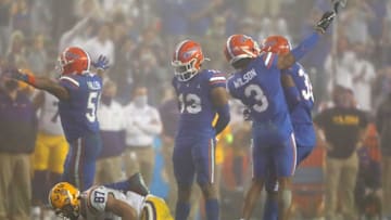 After a tackle Florida Gators defensive back Marco Wilson (3) throws the shoe of LSU tight end Kole Taylor (87) which resulted in a personal foul penalty against Wilson, during a game against the LSU Tigers at Ben Hill Griffin Stadium in Gainesville, Fla. Dec. 12, 2020. Florida lost 37-34 to the Tigers.Sports Mcclenny02
