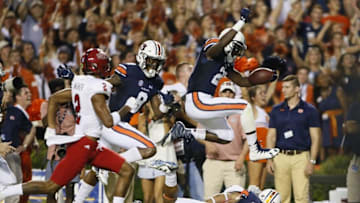 Sep 10, 2016; Auburn, AL, USA; Auburn Tigers running back Kerryon Johnson (21) hurdles players as receiver Tony Stephens (8) blocks Arkansas State Red Wolves cornerback Nehemiah Wagner (2) during the first quarter at Jordan Hare Stadium. Mandatory Credit: John Reed-USA TODAY Sports