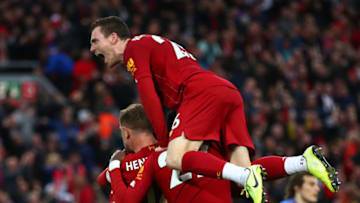 LIVERPOOL, ENGLAND - OCTOBER 05: James Milner of Liverpool celebrates with Jordan Henderson of Liverpool and Divock Origi of Liverpool and Andy Robertson of Liverpool after he scores his sides second goal from the penalty spotduring the Premier League match between Liverpool FC and Leicester City at Anfield on October 05, 2019 in Liverpool, United Kingdom. (Photo by Clive Brunskill/Getty Images)