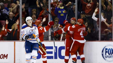 Nov 27, 2015; Detroit, MI, USA; Detroit Red Wings defenseman Niklas Kronwall (55) receives congratulations from left wing Henrik Zetterberg (40) as Edmonton Oilers center Ryan Nugent-Hopkins (93) reacts to an overtime goal by Kronwall at Joe Louis Arena. Detroit won 4-3 in overtime. Mandatory Credit: Rick Osentoski-USA TODAY Sports