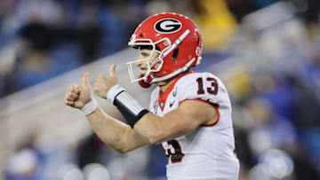 Stetson Bennett #13 of the Georgia Bulldogs celebrates after a touchdown in the 16-6 win over the Kentucky Wildcats at Kroger Field on November 19, 2022 in Lexington, Kentucky. (Photo by Andy Lyons/Getty Images)