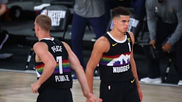 Sep 24, 2020; Lake Buena Vista, Florida, USA; Denver Nuggets forward Michael Porter Jr. (1) celebrates with forward Mason Plumlee (7) during the second half against the Los Angeles Lakers in game four of the Western Conference Finals of the 2020 NBA Playoffs at AdventHealth Arena. Mandatory Credit: Kim Klement-USA TODAY Sports