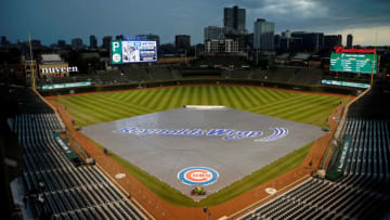 CHICAGO, IL - SEPTEMBER 25: The tarp covers the field as rain moves through the area before the game between the Chicago Cubs and the Pittsburgh Pirates at Wrigley Field on September 25, 2018 in Chicago, Illinois. (Photo by Jon Durr/Getty Images)