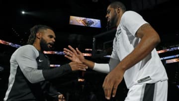 SAN ANTONIO, TX - OCTOBER 7: Patty Mills #8 of the San Antonio Spurs and teammate LaMarcus Aldridge #12 high five before a preseason game against the Houston Rockets on October 7, 2018 at the AT&T Center in San Antonio, Texas. NOTE TO USER: User expressly acknowledges and agrees that, by downloading and or using this photograph, User is consenting to the terms and conditions of the Getty Images License Agreement. (Photo by Edward A. Ornelas/Getty Images)