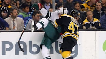 Oct 25, 2016; Boston, MA, USA; Minnesota Wild center Mikael Granlund (64) is checked into the boards by Boston Bruins defenseman Torey Krug (47) during the second period at TD Garden. Mandatory Credit: Winslow Townson-USA TODAY Sports