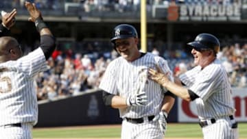 July 20, 2014; New York, NY, USA; New York Yankees player Brian McCann (middle) celebrates after driving in the winning run with an infield single in the 9th inning against the Cincinnati Reds at Yankee Stadium. Mandatory Credit: William Perlman/THE STAR-LEDGER via USA TODAY Sports