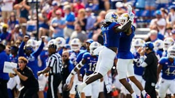 Sep 18, 2021; Lawrence, Kansas, USA; Kansas Jayhawks safety Kenny Logan Jr. (1) celebrates with wide receiver Kwamie Lassiter II (8) after a play against the Baylor Bears during the first half at David Booth Kansas Memorial Stadium. Mandatory Credit: Jay Biggerstaff-USA TODAY Sports