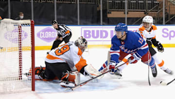 NEW YORK, NEW YORK - MARCH 15: Julien Gauthier #12 of the New York Rangers scores at 15:16 of the second period against Carter Hart #79 of the Philadelphia Flyers at Madison Square Garden on March 15, 2021 in New York City. (Photo by Bruce Bennett/Getty Images)