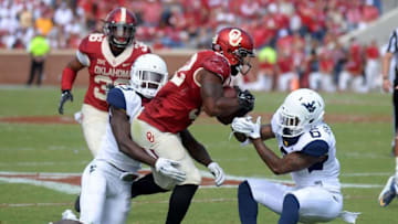 Oct 3, 2015; Norman, OK, USA; Oklahoma Sooners running back Samaje Perine (32) carries the ball as West Virginia Mountaineers linebacker Sean Walters (13) and safety Dravon Askew-Henry (6) defend in the fourth quarter at Gaylord Family - Oklahoma Memorial Stadium. Mandatory Credit: Mark D. Smith-USA TODAY Sports