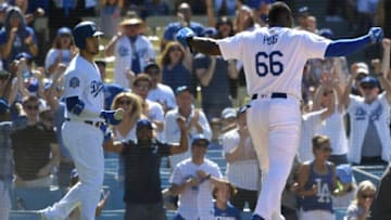 LOS ANGELES, CA - JULY 01: Yasiel Puig #66 of the Los Angeles Dodgers celebrates after crossing the plate against the Colorado Rockiesin the eighth inning at Dodger Stadium on July 1, 2018 in Los Angeles, California. (Photo by John McCoy/Getty Images)