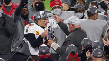 GREEN BAY, WISCONSIN - JANUARY 24: Tom Brady #12 of the Tampa Bay Buccaneers celebrates with head coach Bruce Arians and teammates after their 31 to 26 win over the Green Bay Packers during the NFC Championship game at Lambeau Field on January 24, 2021 in Green Bay, Wisconsin. (Photo by Stacy Revere/Getty Images)