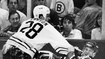 BOSTON, MA - MAY 4: Boston Bruins player Reed Larson, left, and New Jersey Devils player Pat Conacher, right, during a game at the Boston Garden in Boston on May 10, 1988. (Photo by Paul R. Benoit/The Boston Globe via Getty Images)