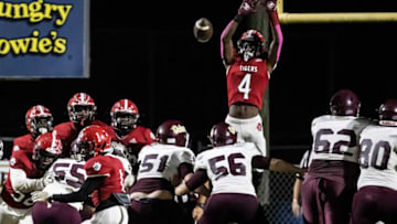 Tiger sophomore Jordan Pride goes up but canÕt stop a Baker extra point. Blountstown hosted Baker under the lights for Friday night football October 22, 2021.017 102221 Blountstown Vs Baker Fb