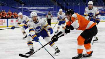 Feb 28, 2021; Buffalo, New York, USA; Buffalo Sabres center Jean-Sebastien Dea (15) tries to block a shot by Philadelphia Flyers right wing Nicolas Aube-Kubel (62) during the third period at KeyBank Center. Mandatory Credit: Timothy T. Ludwig-USA TODAY Sports