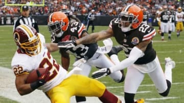 Dec 16, 2012; Cleveland, OH, USA; Washington Redskins running back Evan Royster (22) is forced out of bounds by Cleveland Browns strong safety T.J. Ward (43) and cornerback Joe Haden (23) during the second quarter at Cleveland Browns Stadium. Mandatory Credit: Ron Schwane-USA TODAY Sports
